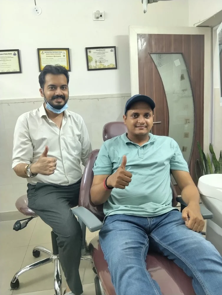Painless wisdom tooth extraction patient smiling with Dr. Rijul