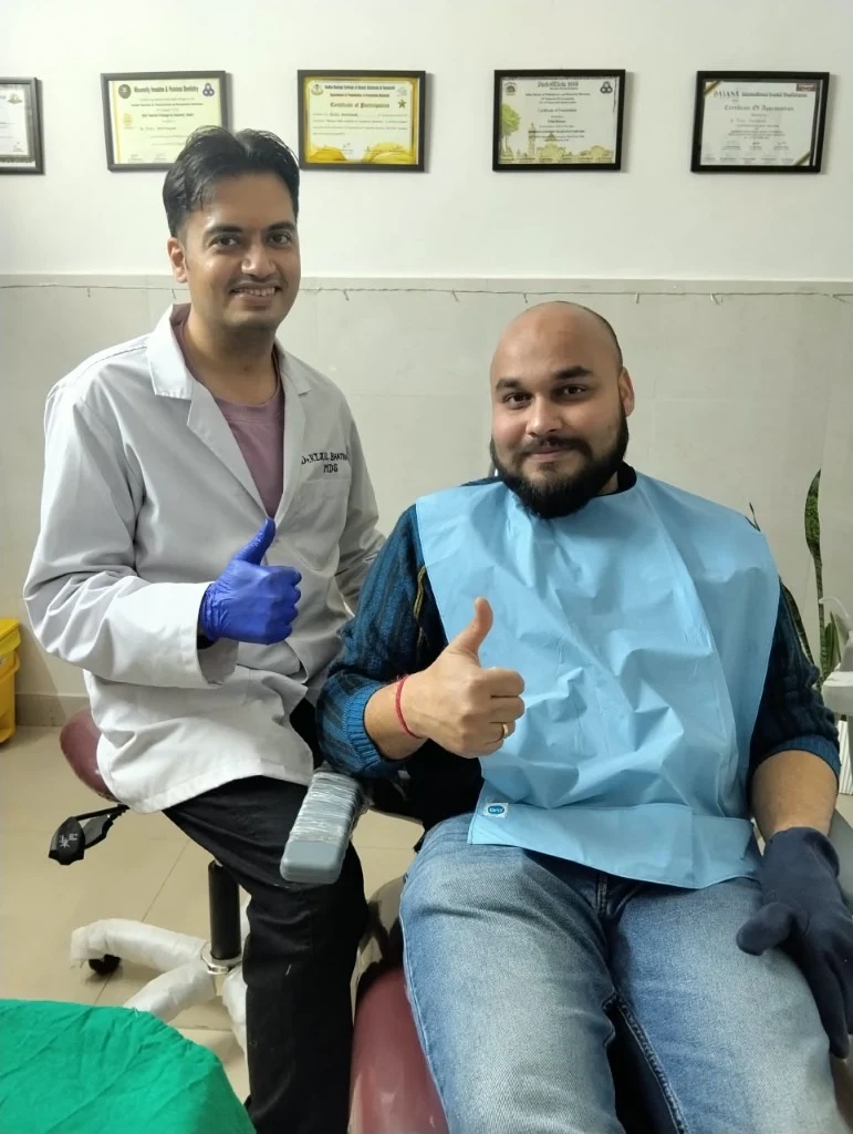 Happy dental implant patient smiling with Dr. Rijul